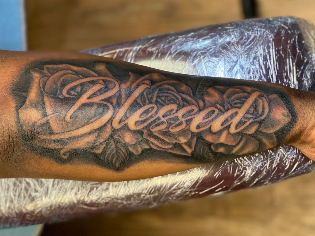 Blessed lettering tattoo on Trae Youngs inner